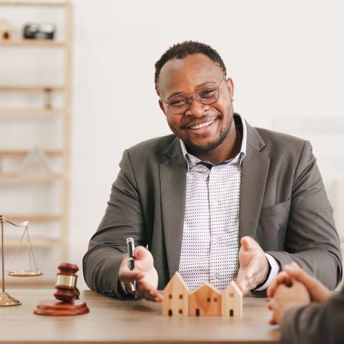 Image: a property manager looking at the camera.